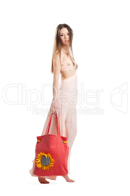 Beauty girl walk in rose dress and red beach bag