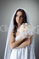 Beauty young bride portrait with bunch of flowers