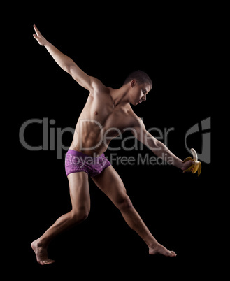 nude athletic striptease man posing with banana