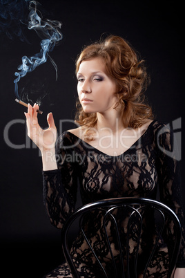Sexy woman in black lace body shirt smoke in dark