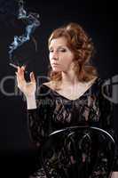 Sexy woman in black lace body shirt smoke in dark