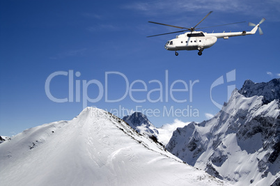 Helicopter in snowy mountains