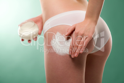 Woman apply cellulite cream on bottom