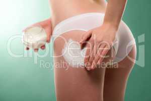 Woman apply cellulite cream on bottom