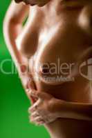 Naked woman massage lubricate oil on belly