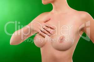 Naked woman breasts beautiful body on green