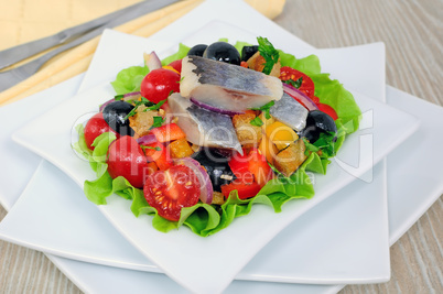 Appetizer of herring and vegetables with croutons