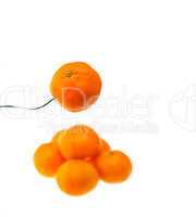 orange mandarin tangerine on fork over white