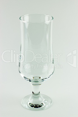 Empty tall transparent wineglass on white