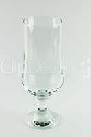 Empty tall transparent wineglass on white