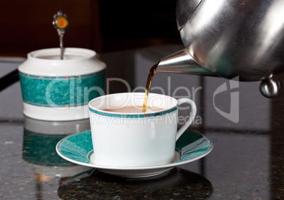 Tea poured from stainless steel teapot