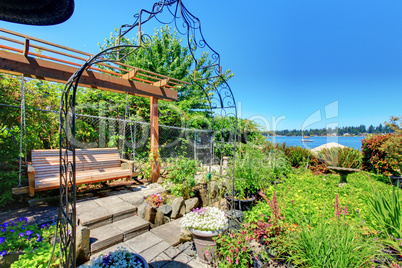 Private home Garden with a swinging bench near the lake.