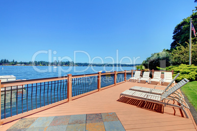 Lake waterfront deck with beach laying down chairs