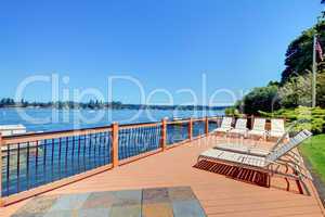 Lake waterfront deck with beach laying down chairs