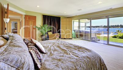 Large yellow bedroom with lake view and hot tub
