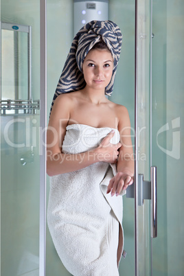 Beautiful girl after a shower in a white towel