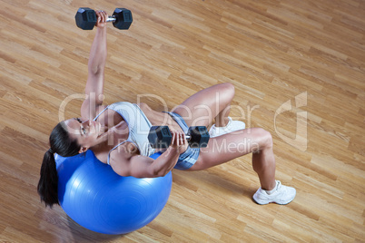 Athletic trainer shows examples of exercises in the gym