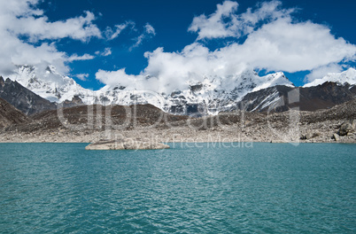 Clouds and Sacred Lake near Gokyo in Himalayas