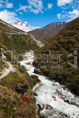 Himalaya landscape: peak, river and highland village