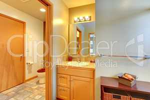 Large bathroom with double sinks and tub with grey rug.