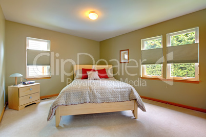 Large and bright guest bedroom with lots of windows.