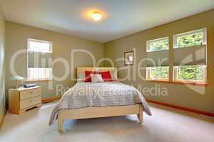 Large and bright guest bedroom with lots of windows.
