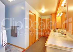 Bathroom house interior with many doors to closets.