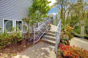 Large grey house exterior of modern home with walkway.