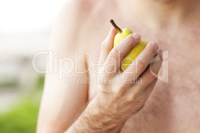 man holding a pear in his hand