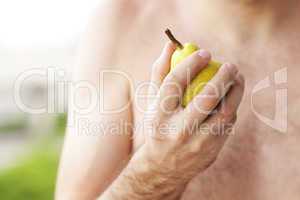 man holding a pear in his hand