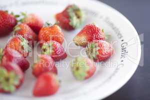 strawberries on a plate on a wooden table