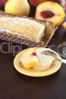 peach, pear, plum, coconut cake and spoon on a wooden table