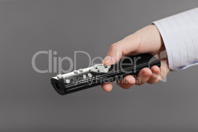 Human hand holding tv channel remote control