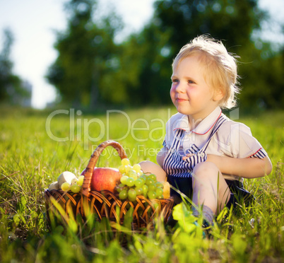 little boy with a basket of fruit