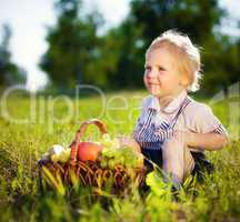 little boy with a basket of fruit