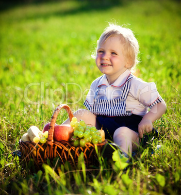 little boy with a basket of fruit