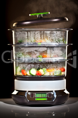 Healthy cooking, steam cooker with vegetables