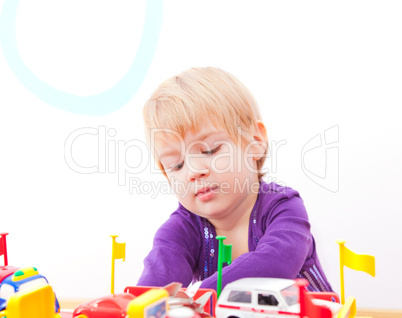 Cheerful little girl playing with toys