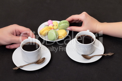 Couple drinking coffee with macaroon