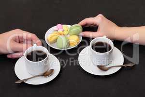 Couple drinking coffee with macaroon