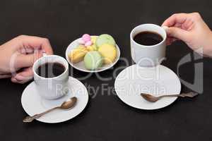 Couple drinking coffee with macaroon