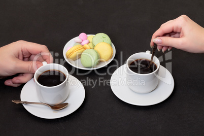 Couple drinking coffee with macaroon