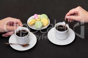 Couple drinking coffee with macaroon