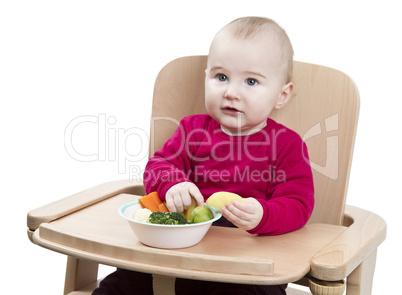 young child eating in high chair