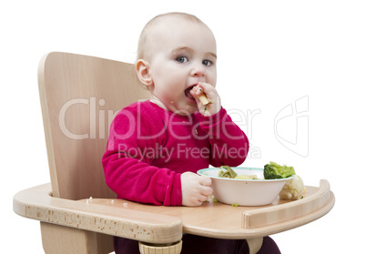 young child eating in high chair