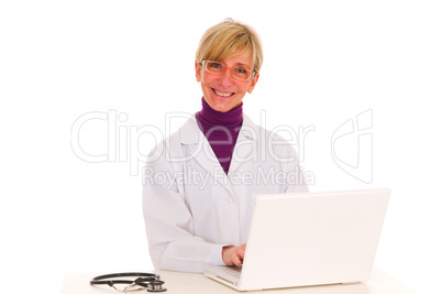 female doctor at the desk with stethoscope and laptop