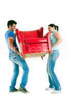 Couple carrying a chair