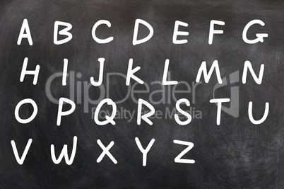 English alphabet handwritten with white chalk on a blackboard