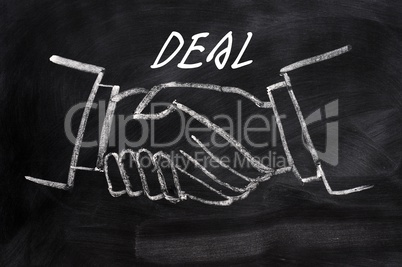 Business deal written on a blackboard background with handshaking