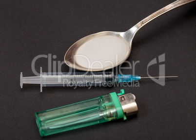 Syringe, spoon, heroin and lighter